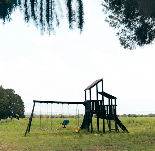 Timber playground in a green outdoor learning space
