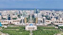 Modern cityscape with grand architecture and green spaces.