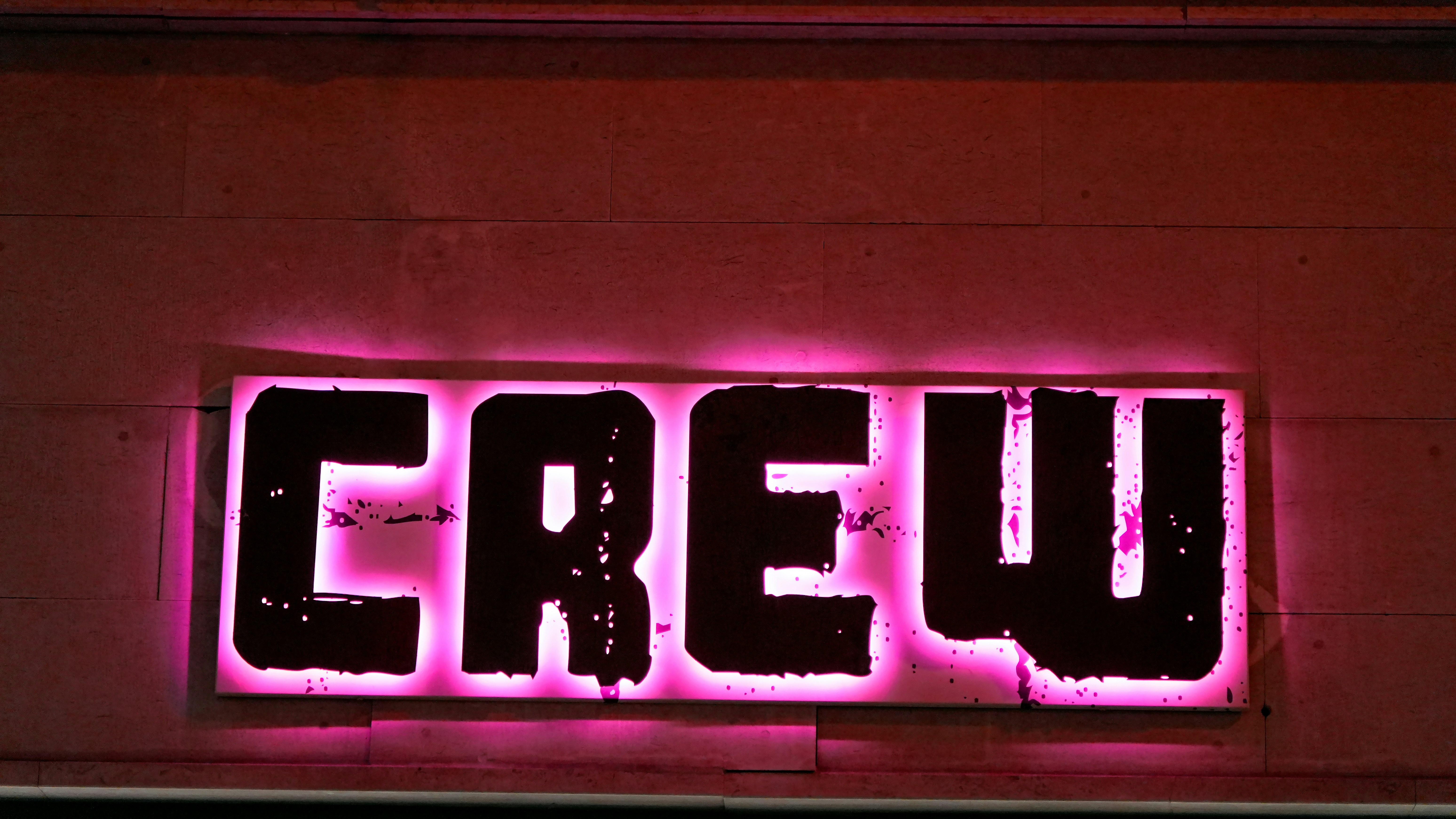 Illuminated sign spelling out the word crew