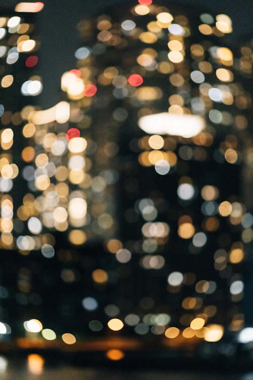 Blurred city lights at night, representing reduced contrast vision