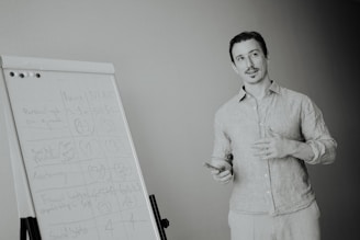 Man presenting at a whiteboard in a meeting.