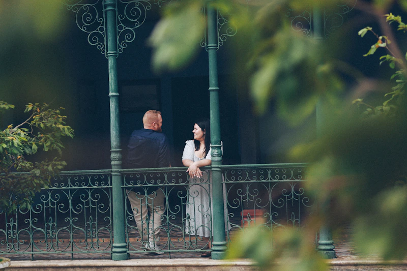 Couple standing on a balcony talking