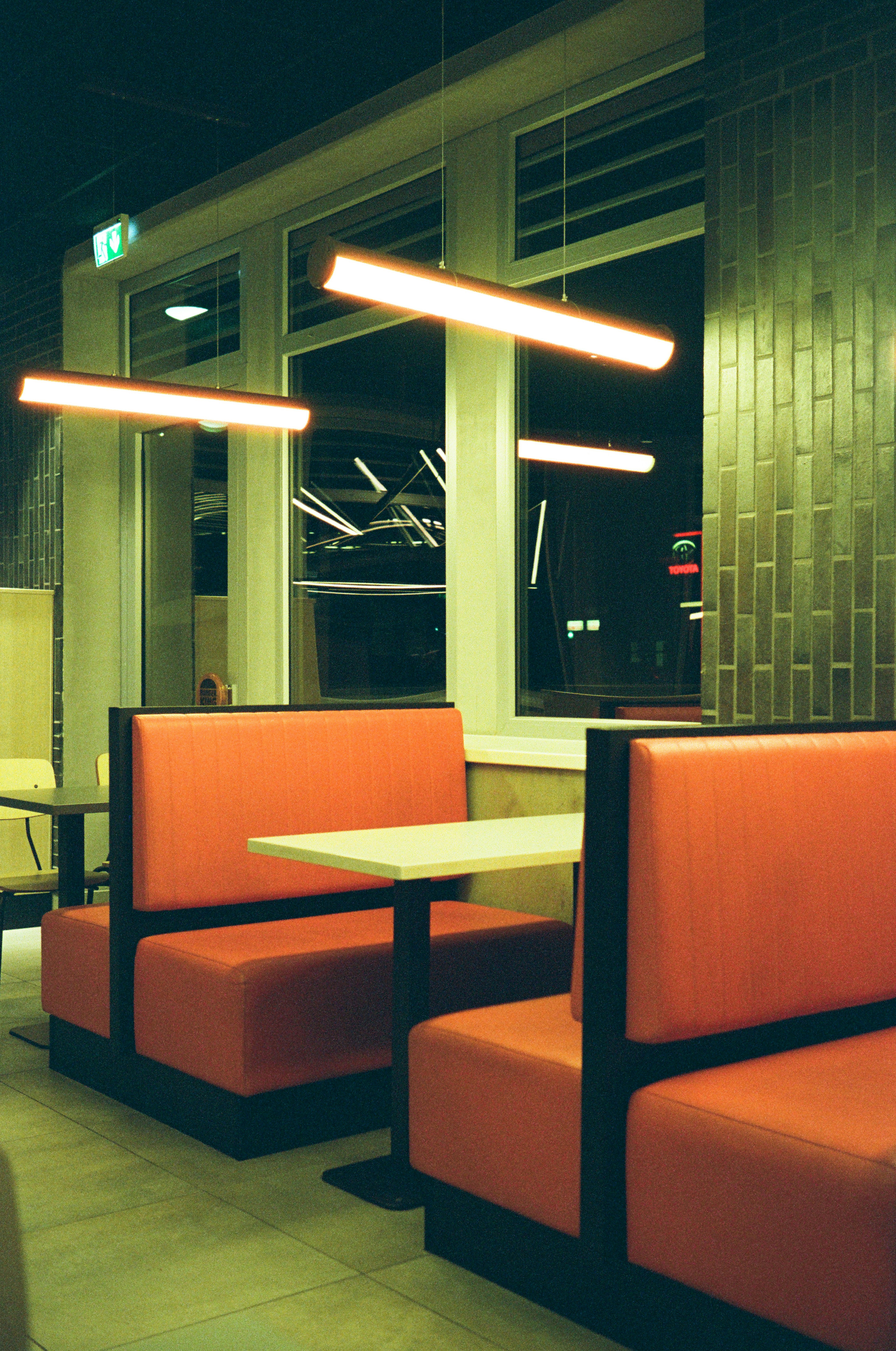 Orange booths and tables in a modern diner