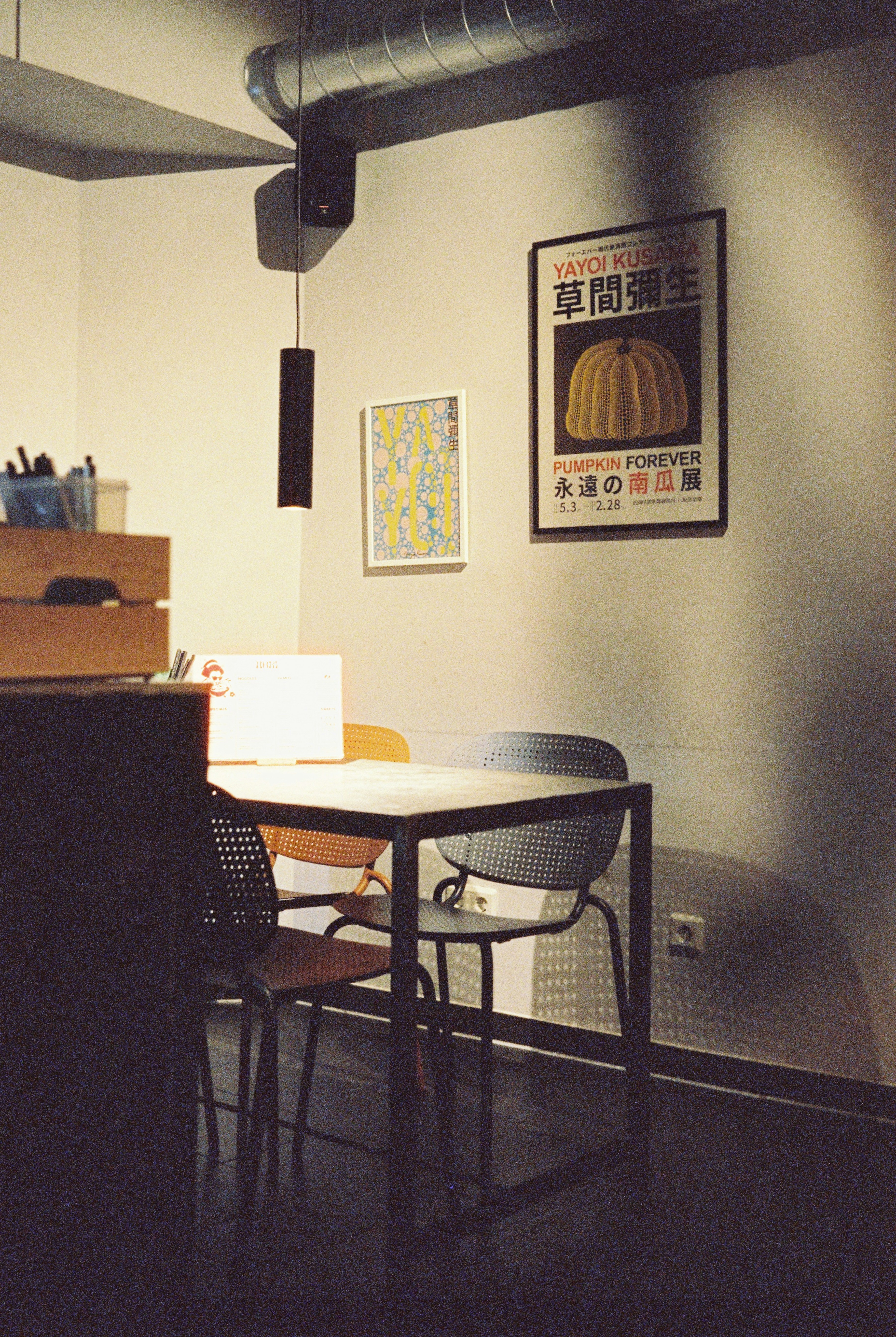 A modern dining area with artwork on wall.