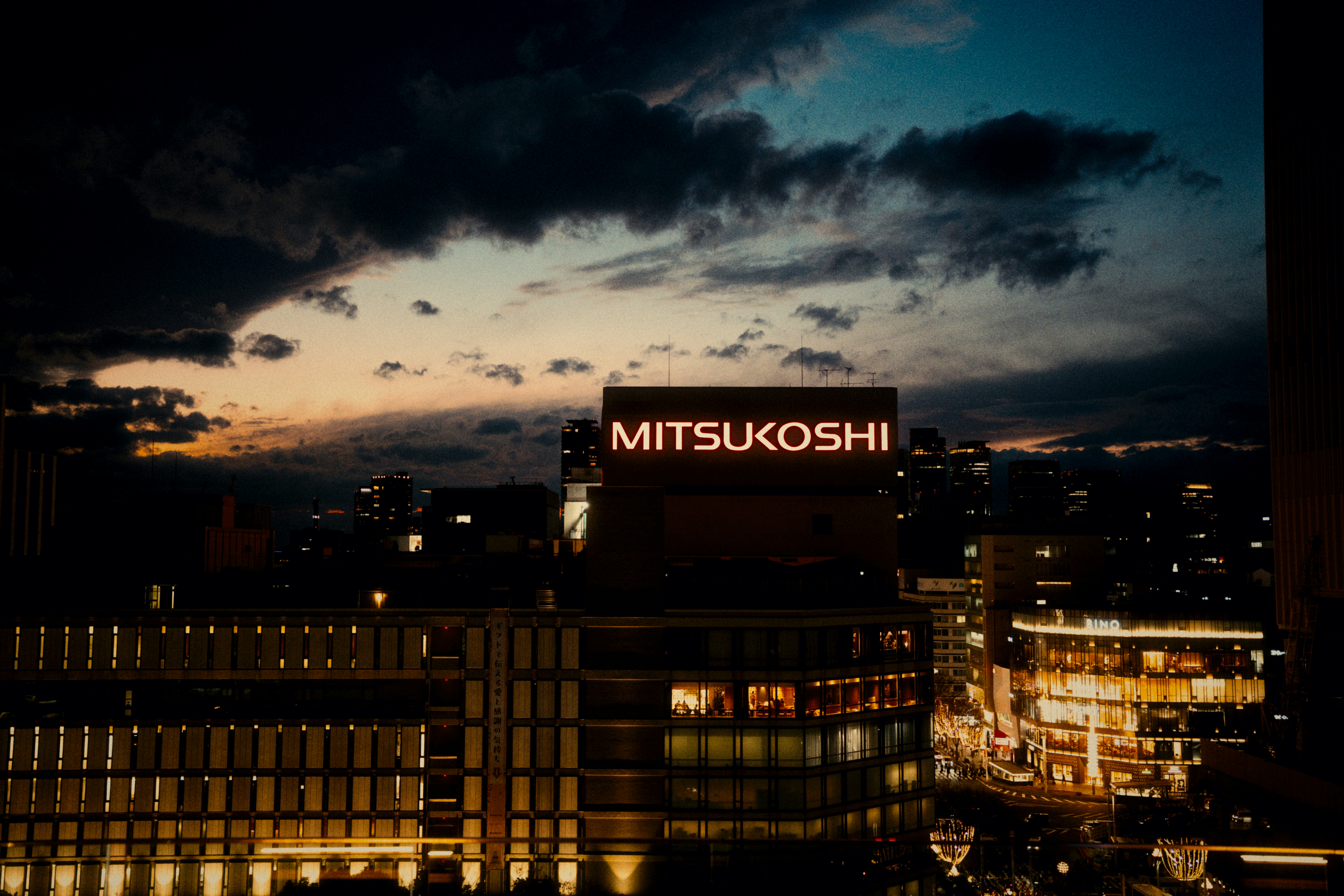 City skyline at dusk with mitsukoshi building illuminated