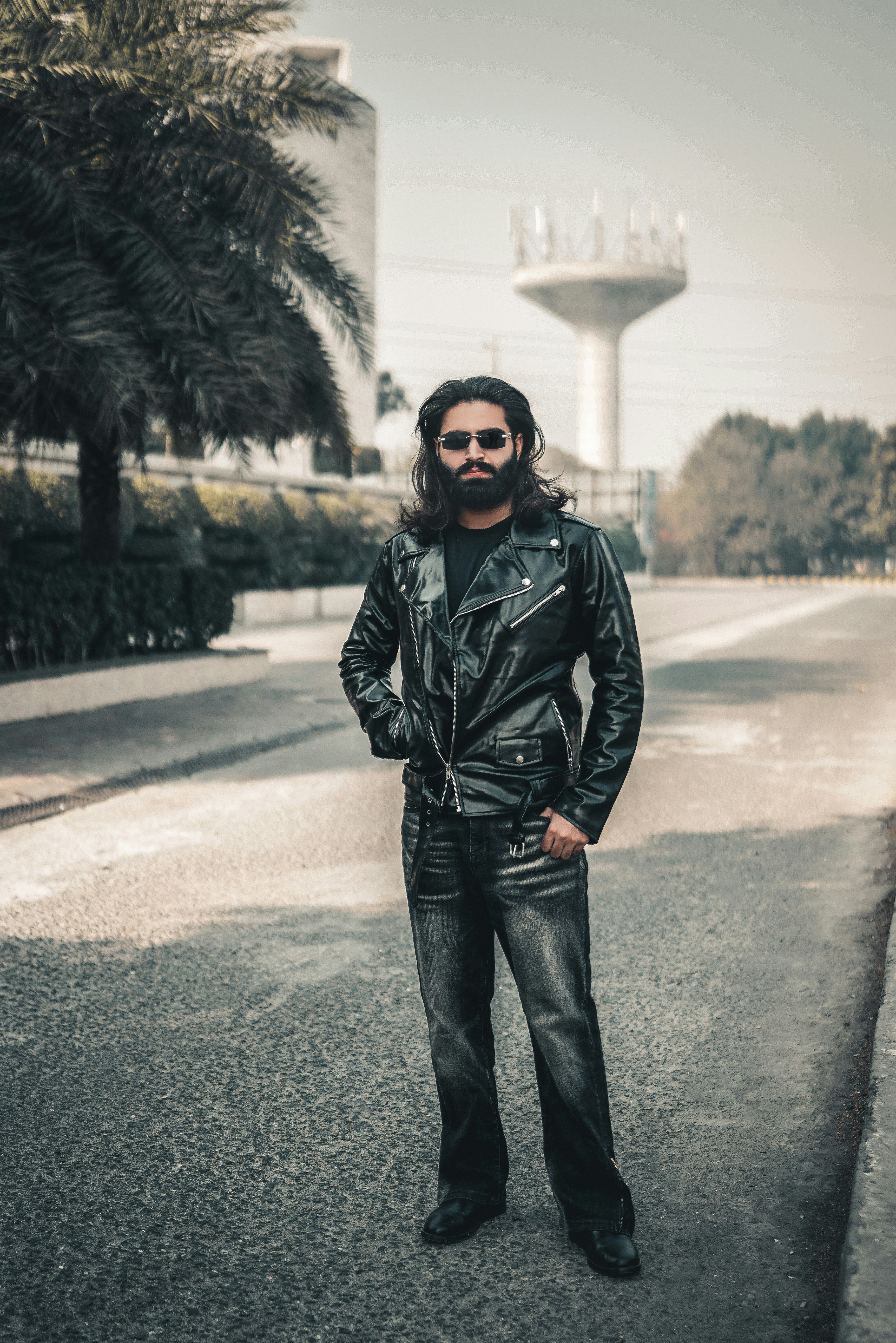 Man in leather jacket standing outdoors
