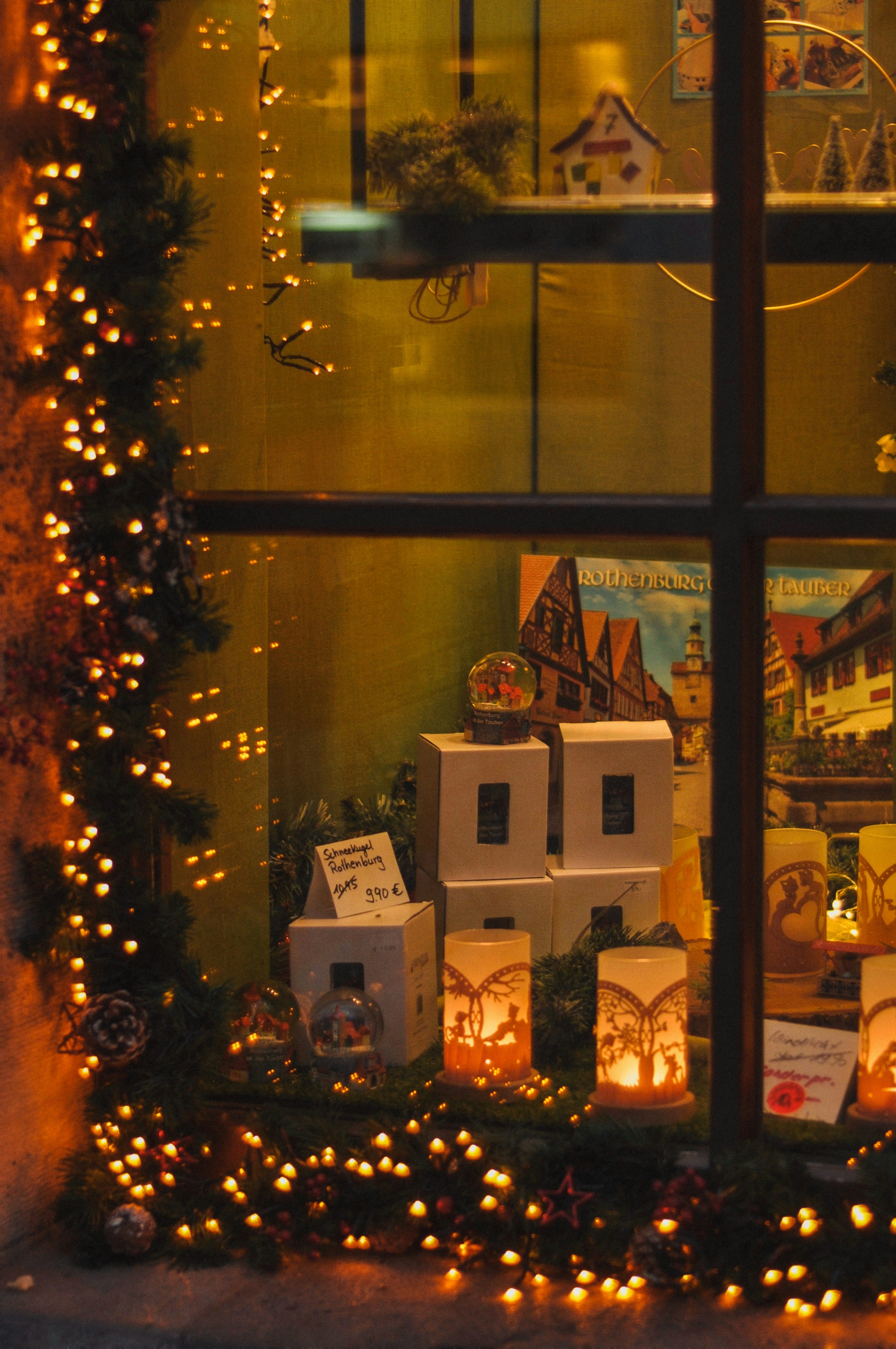 Christmas window display with festive lights and decorations