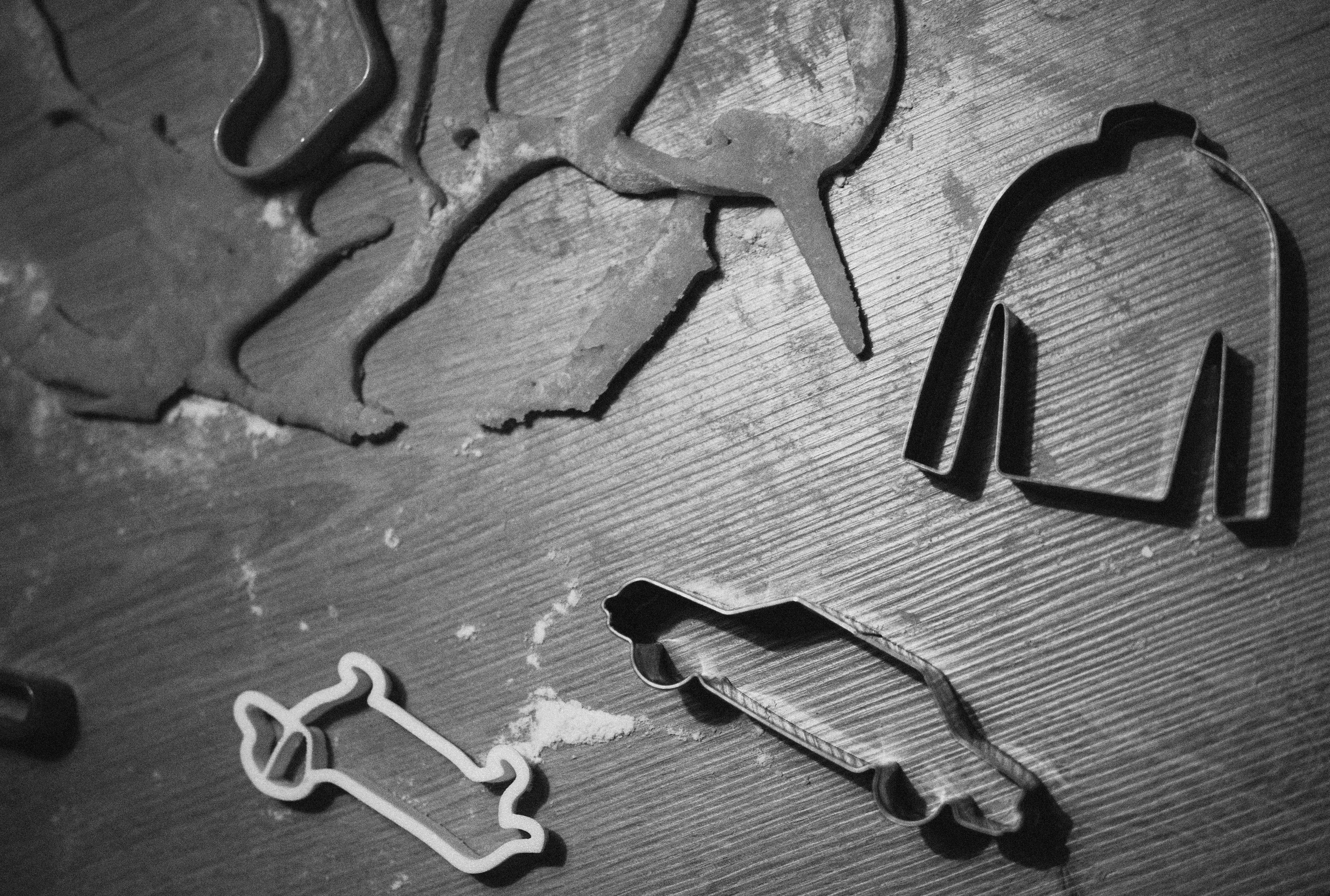 Cookie cutters and dough on a wooden surface