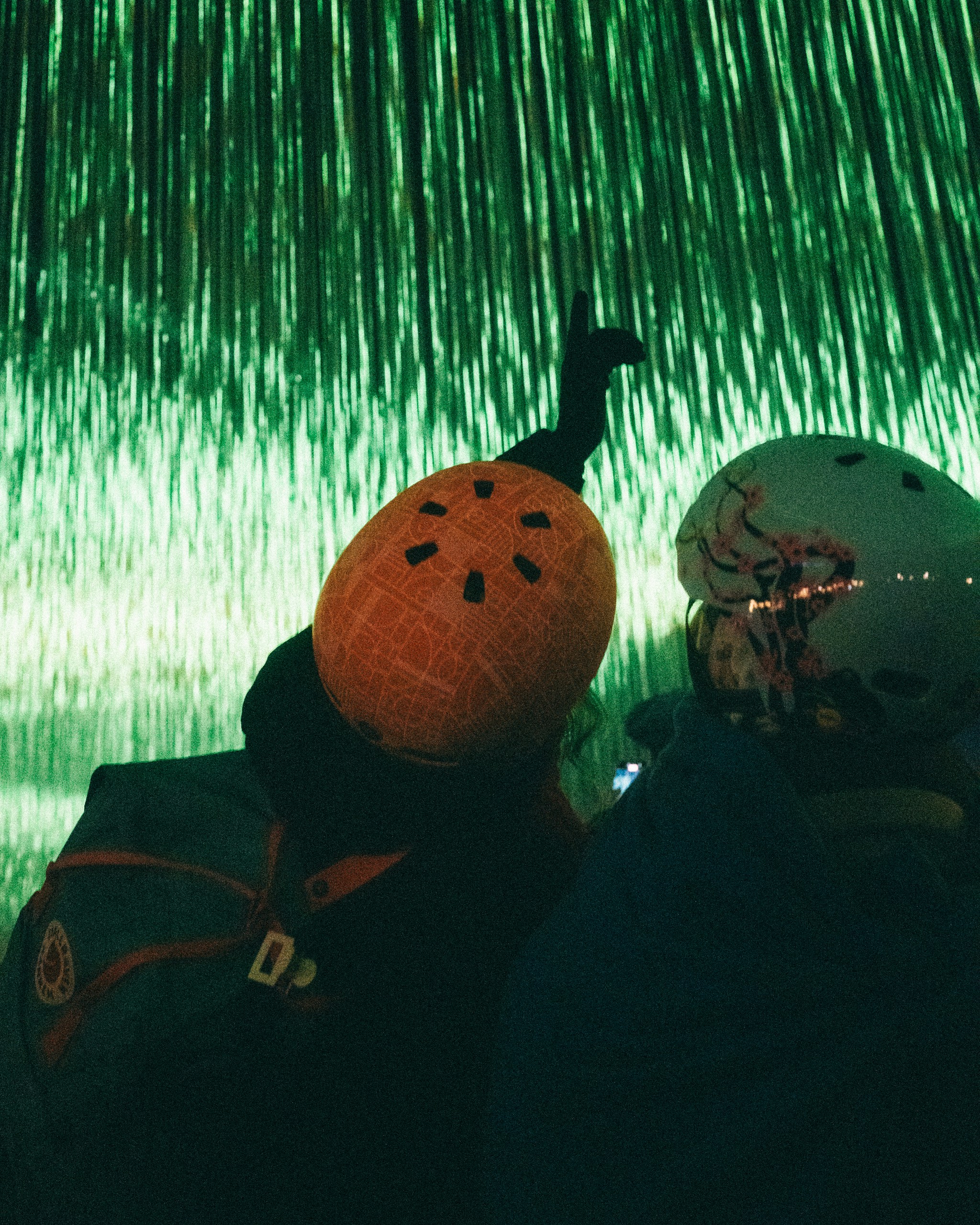 Two people wearing helmets at night