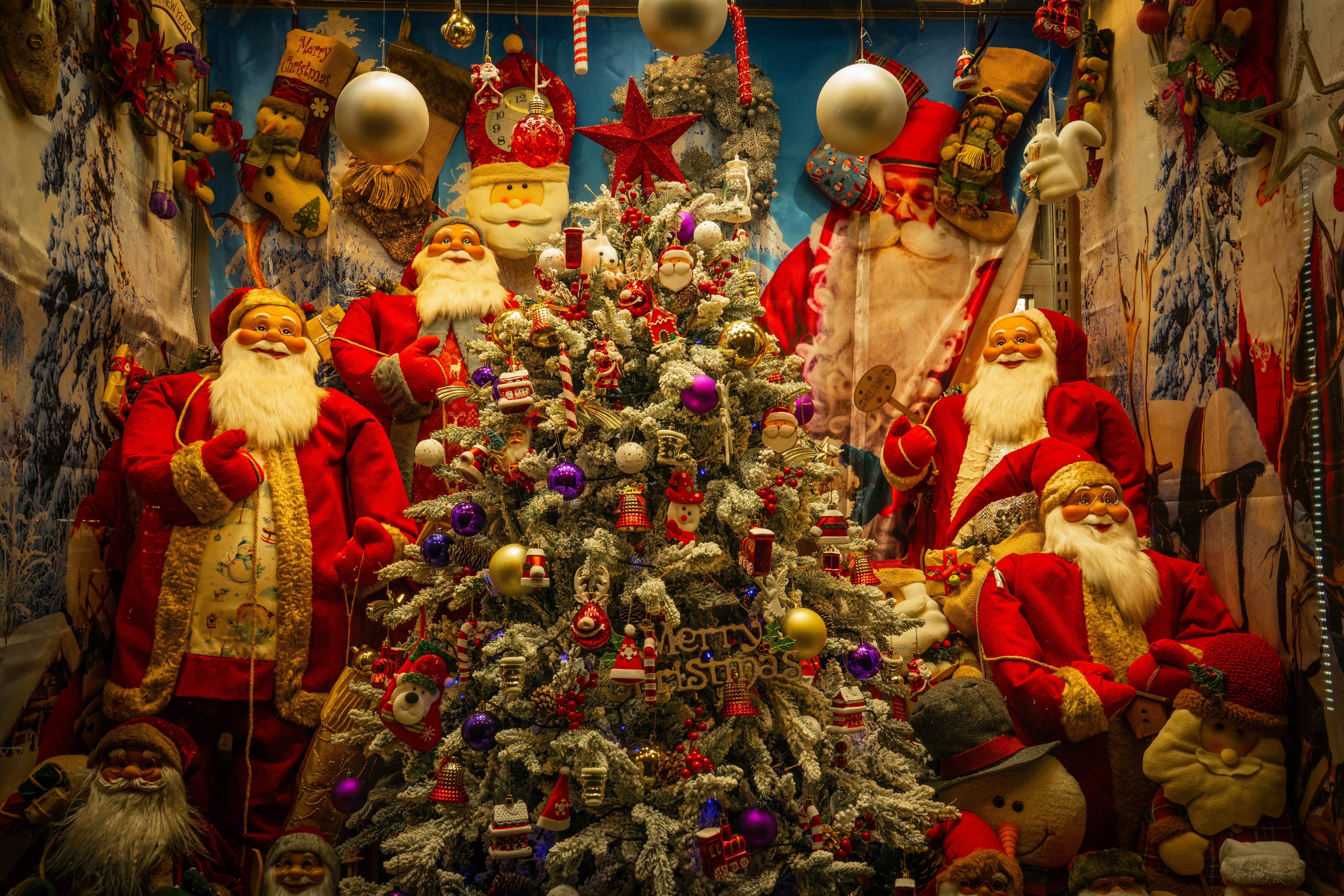 Christmas tree surrounded by many santa claus figures.