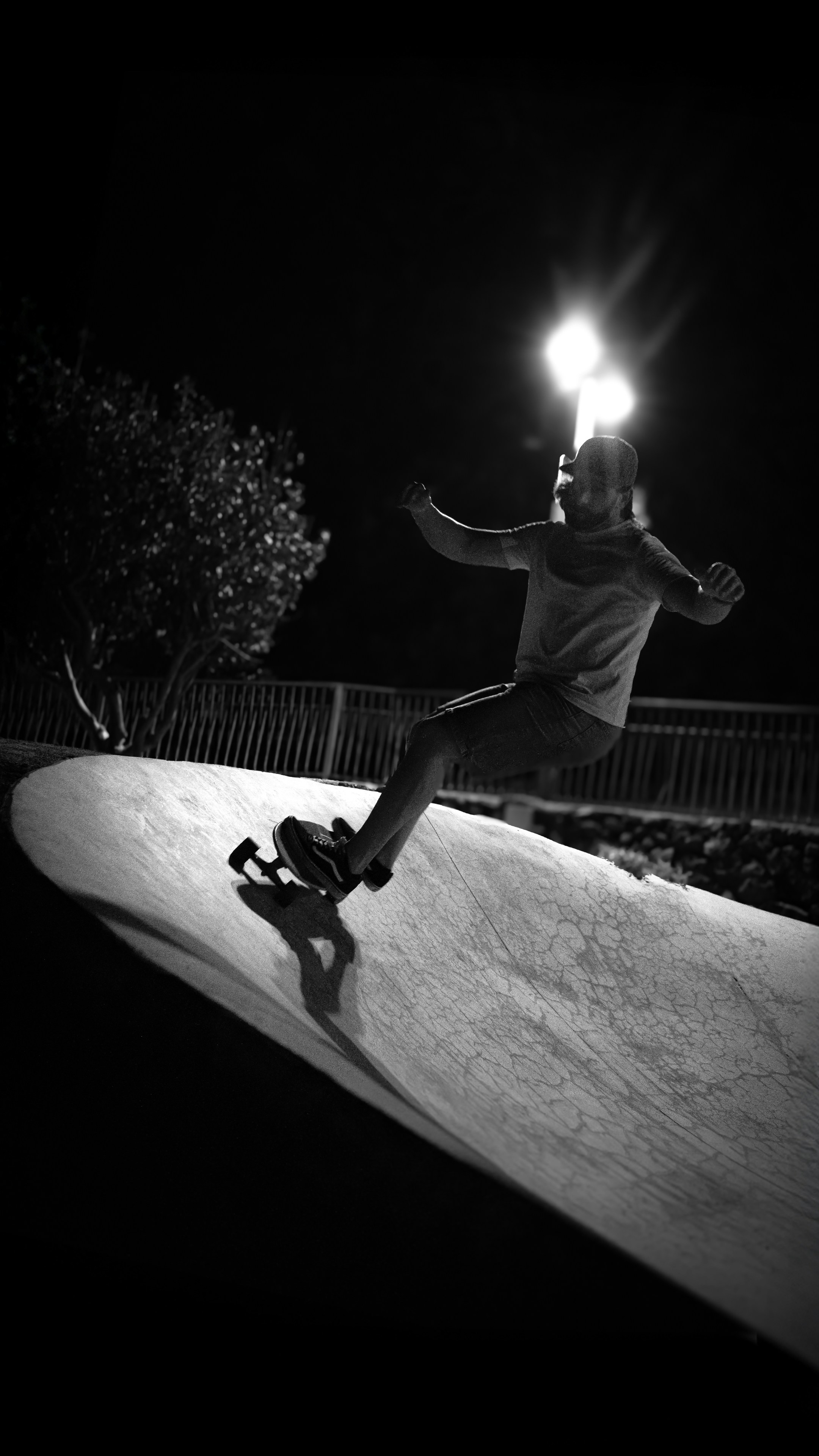 Man skateboarding on a ramp at night