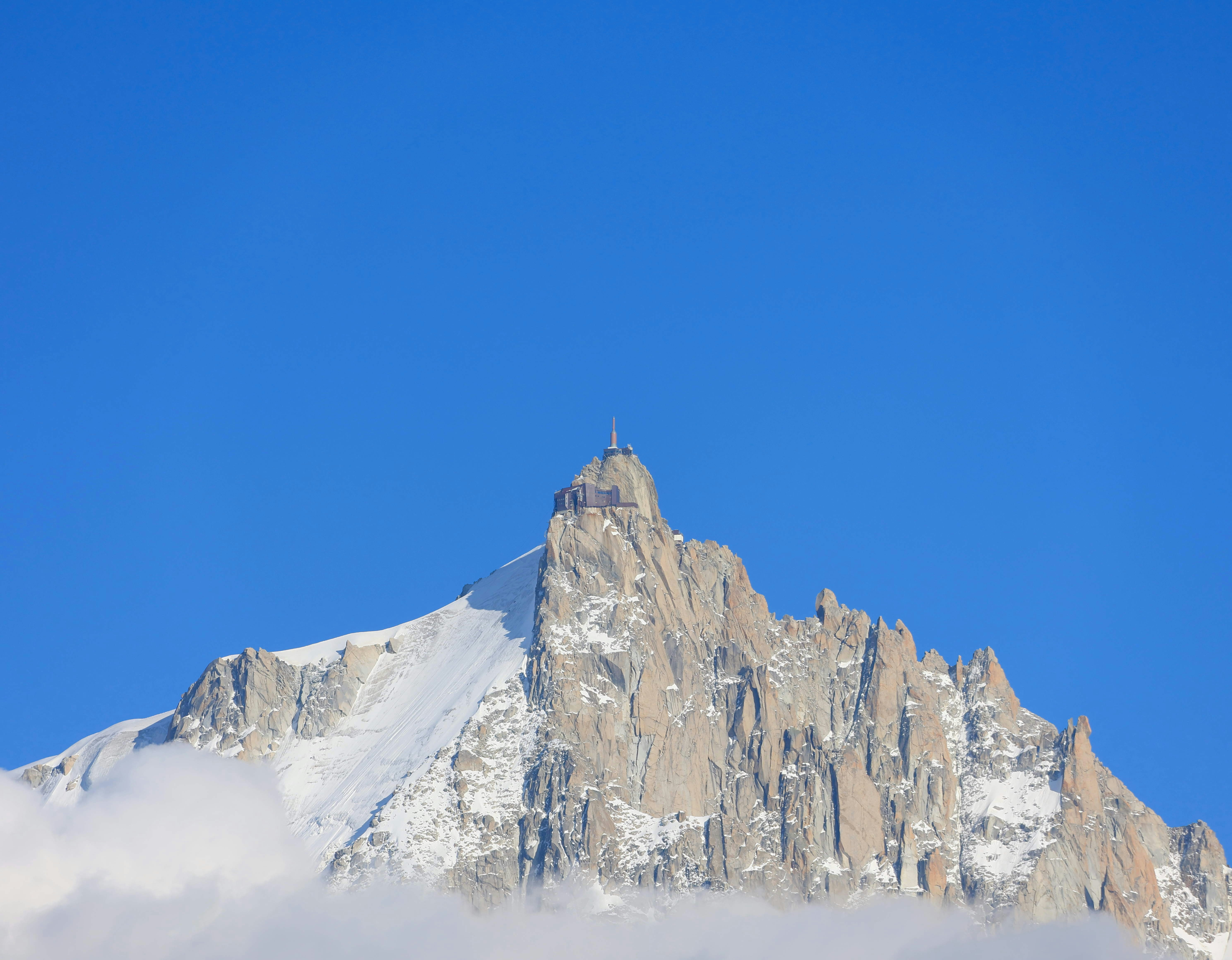 Snow-capped mountain peak against a clear blue sky.