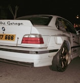 Modified white BMW with "art garage" sticker
