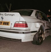Modified white BMW with "art garage" sticker