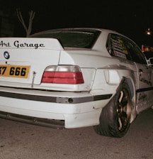 Modified white BMW with "art garage" sticker