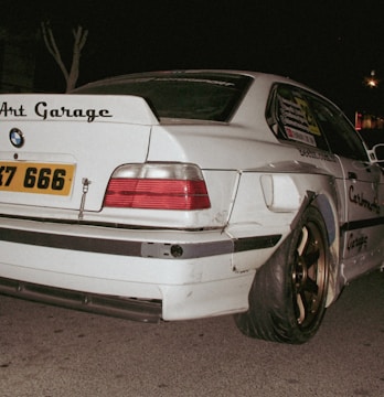 Modified white BMW with "art garage" sticker