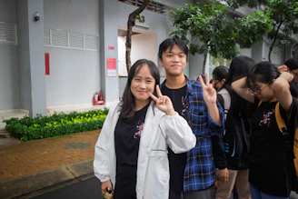 Two young people pose for a picture outdoors