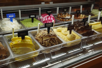 Assortment of colorful gelato flavors in display case.