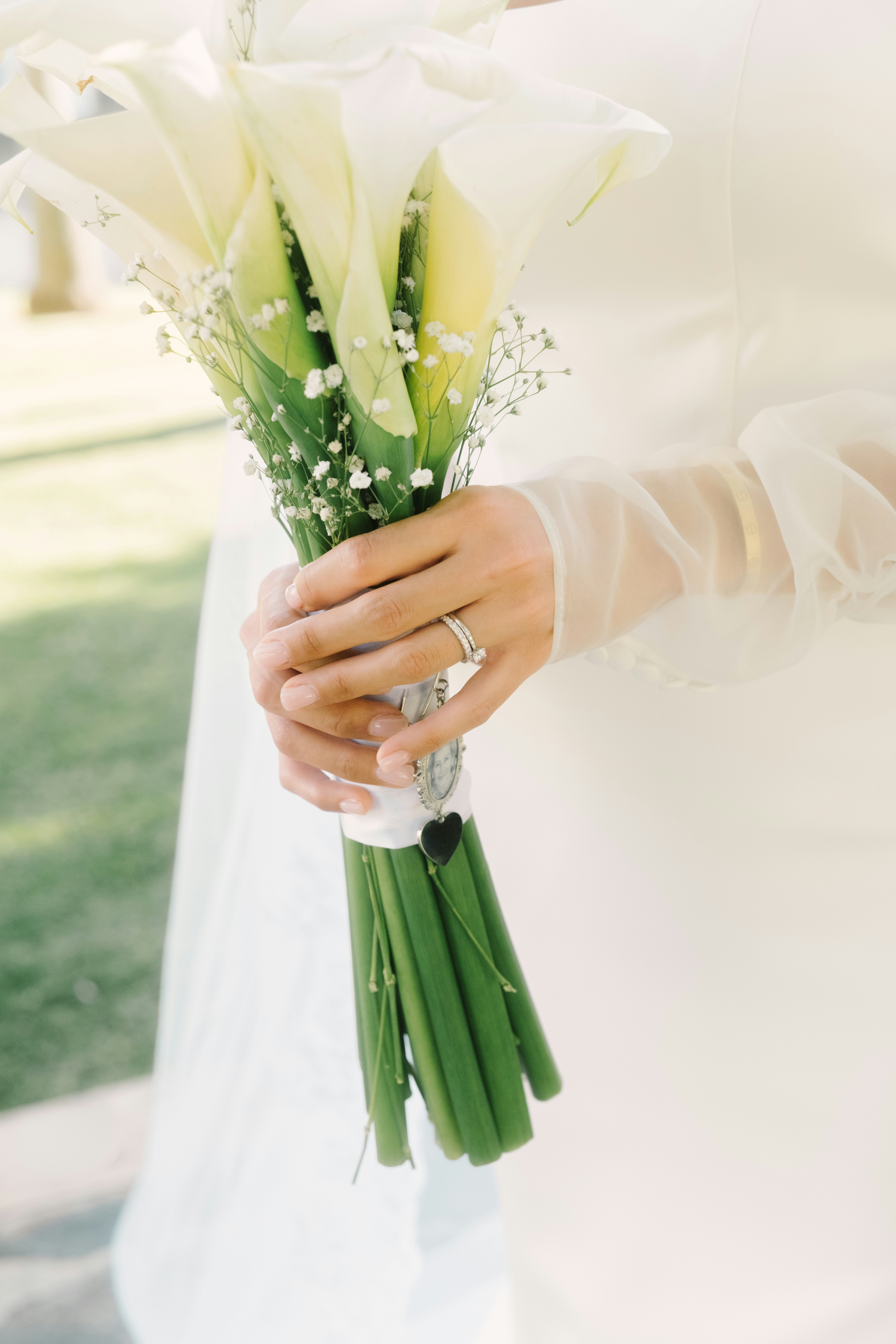 Bride holding a bouquet of white calla lilies