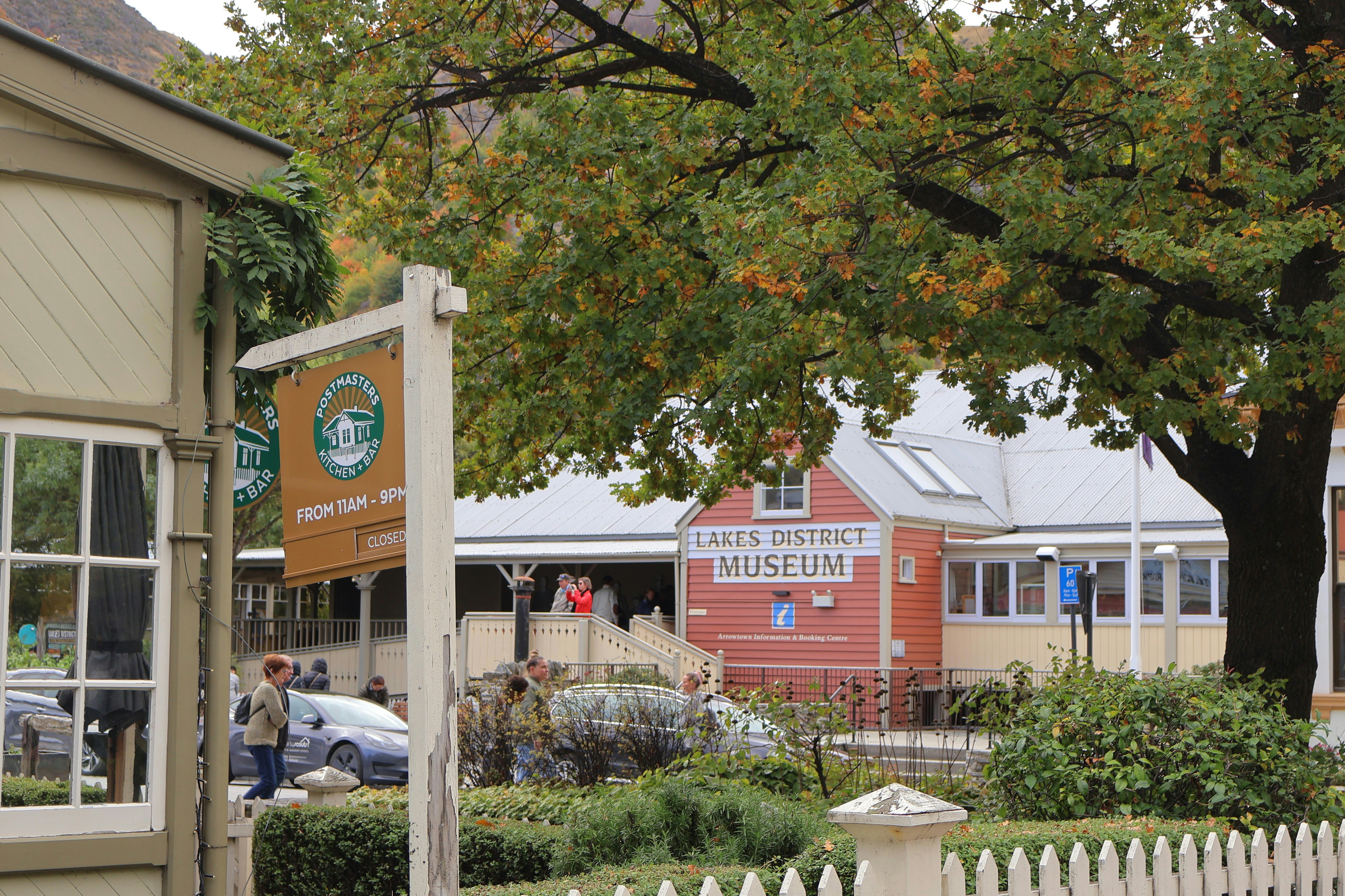 Queenstown district museum building with autumn trees.