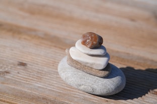 Stack of balanced stones on a wooden surface