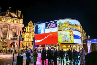 Vibrant cityscape at night with illuminated billboards.