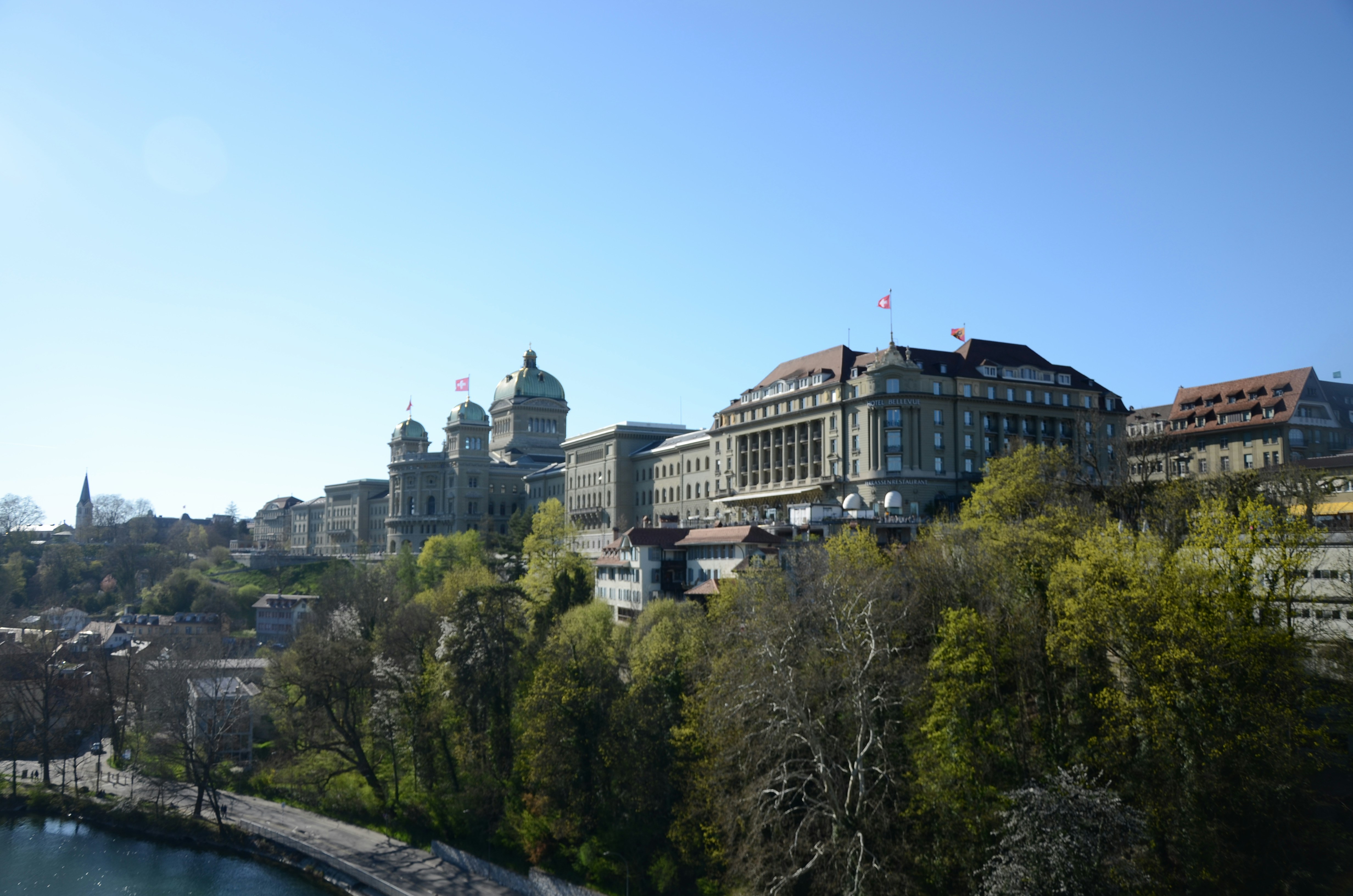City buildings on a hill overlooking a river.