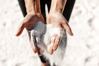 Hands holding and letting sand fall through.