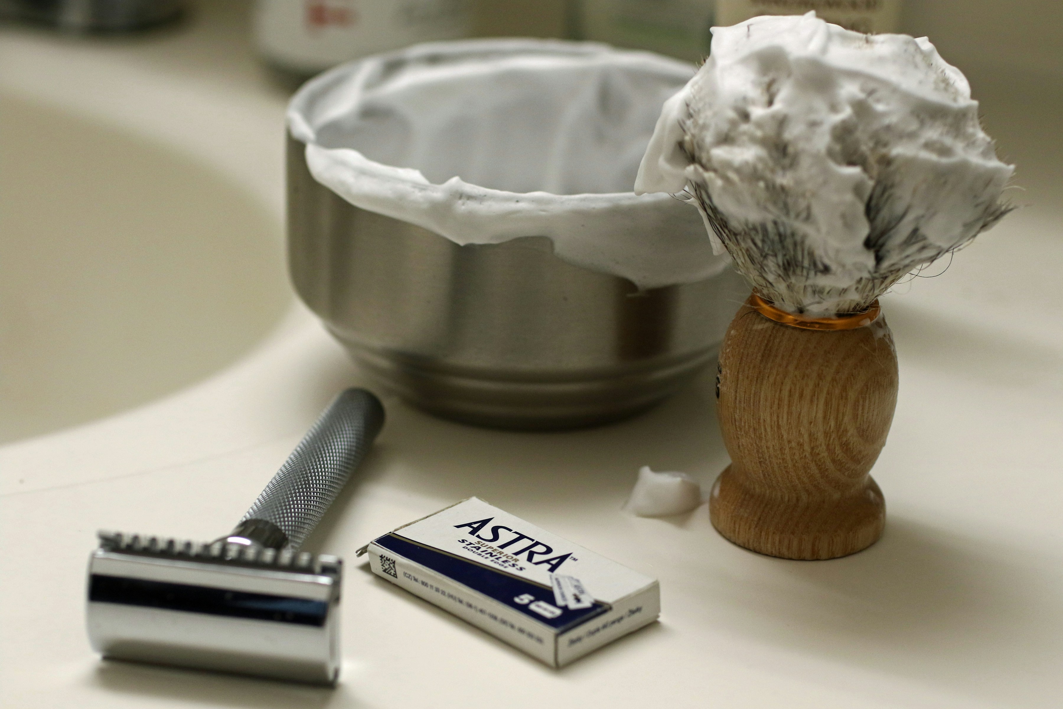 Shaving brush, razor, and blades on counter