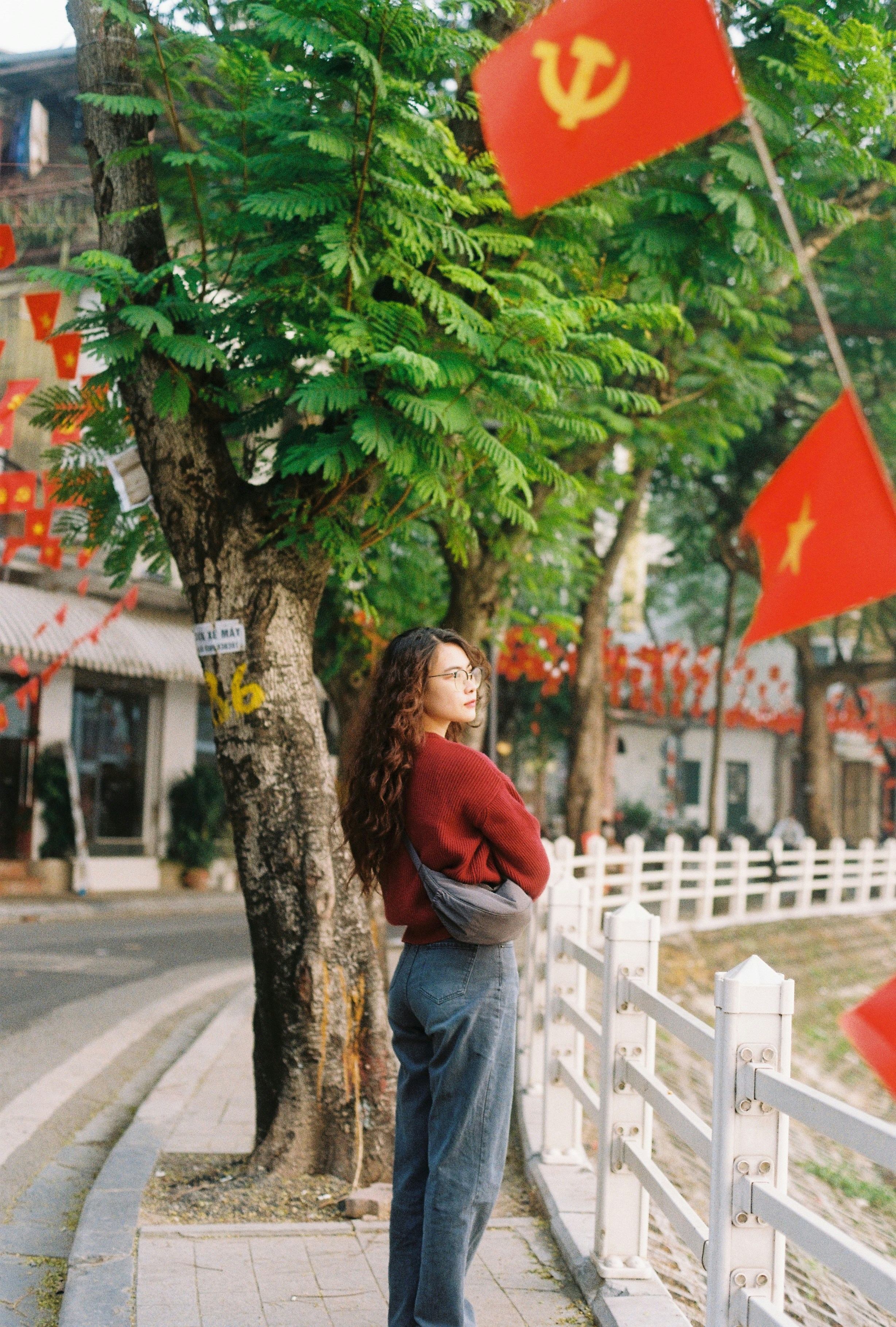 Woman standing outdoors with red flags