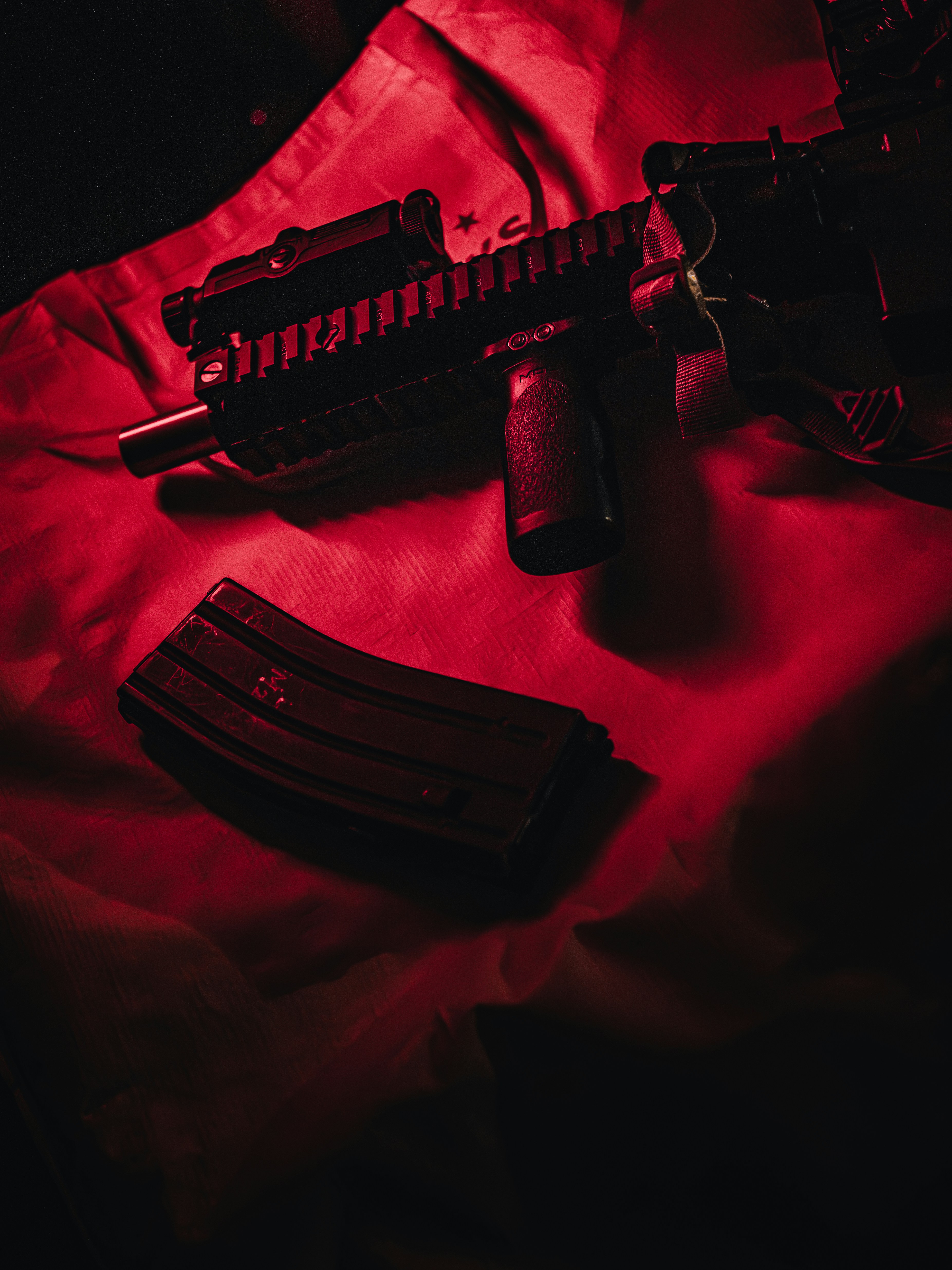 Rifle and magazine illuminated by red light