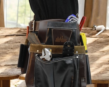 Tool belt filled with various hand tools