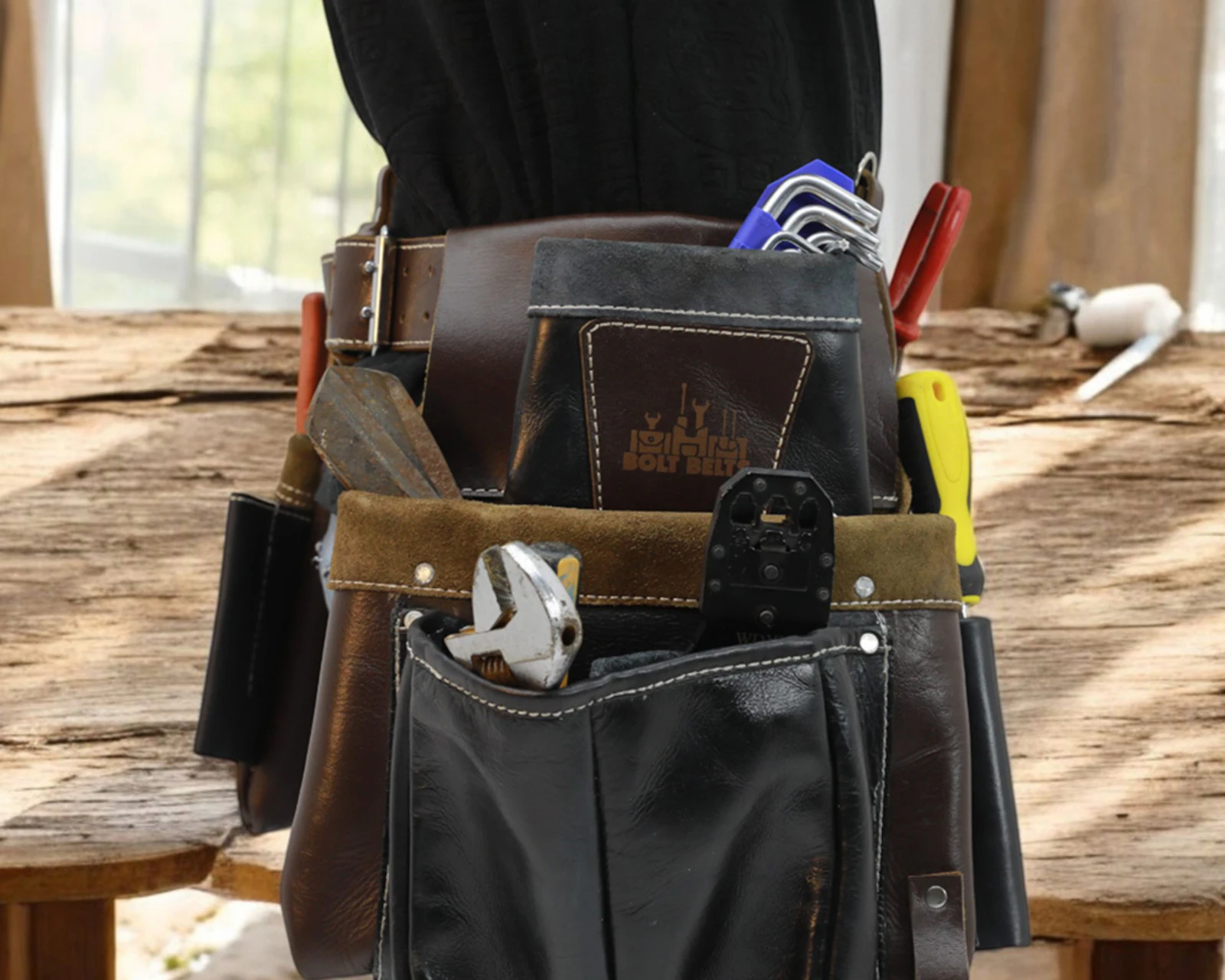Handyman with tool belt using a drill on an interior door