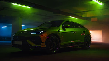 Green luxury suv parked in a dimly lit garage.