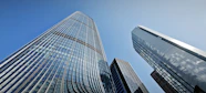 Modern glass skyscrapers against a clear blue sky