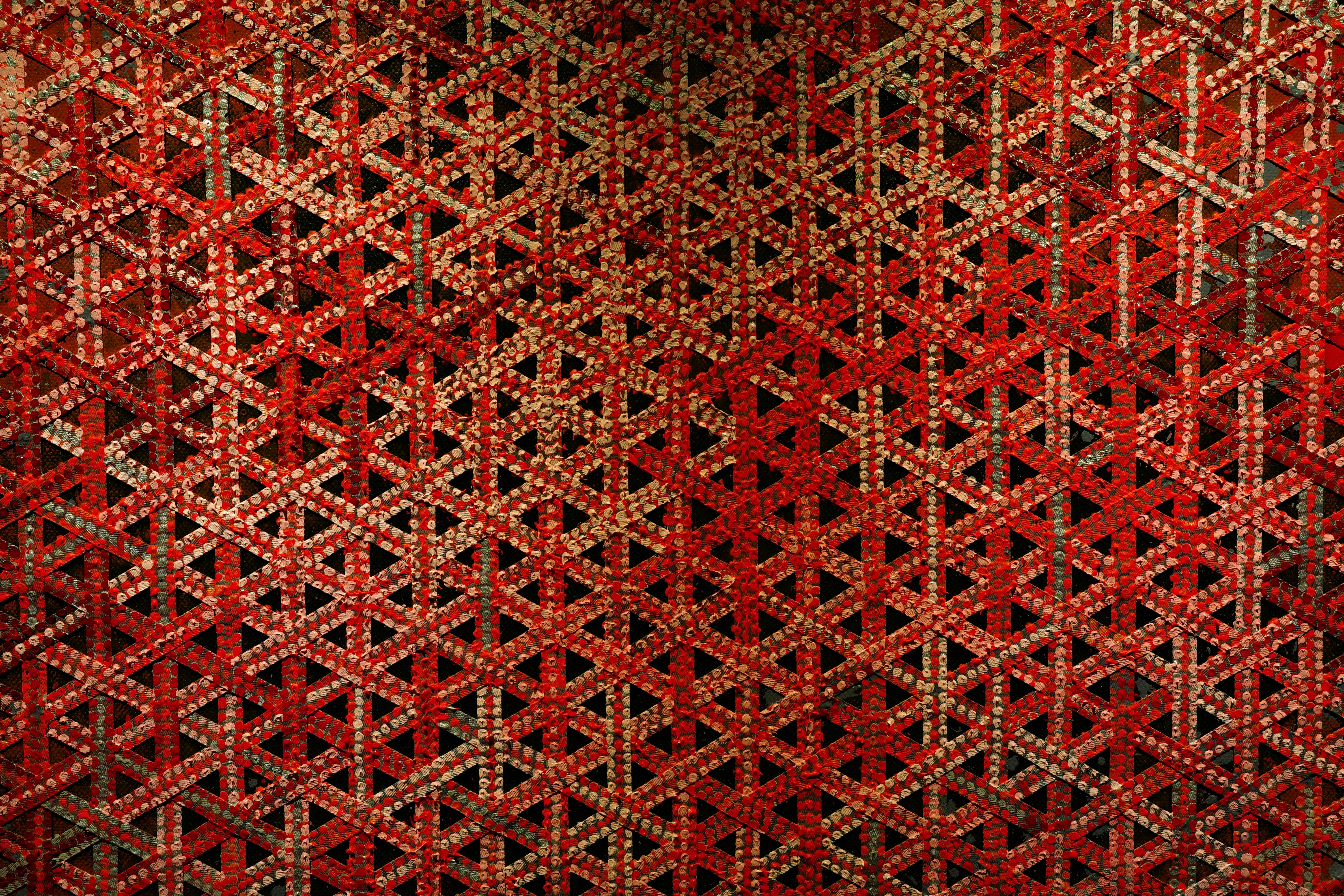 Intricate red and beige geometric woven pattern
