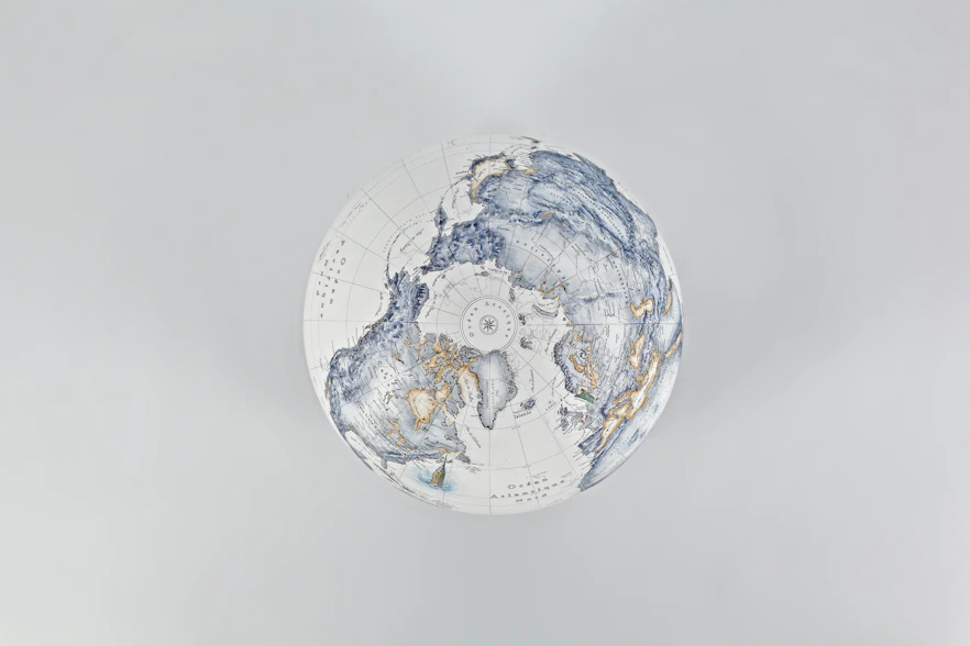 A stylized globe with intricate blue and gold patterns.