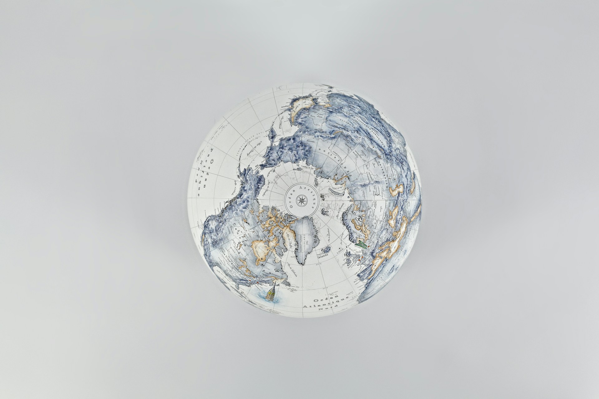 A stylized globe with intricate blue and gold patterns.