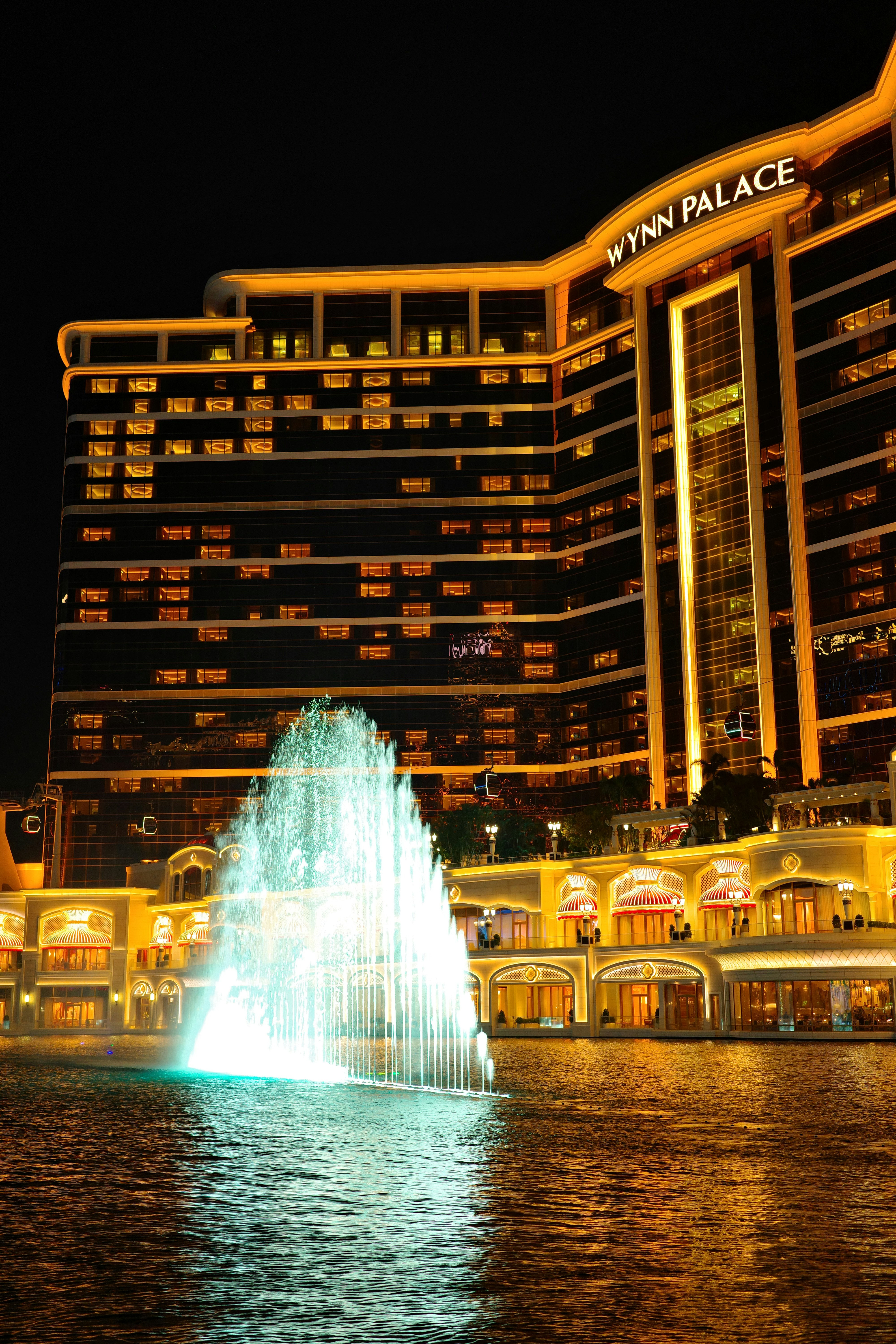 Wynn palace hotel with illuminated fountain at night