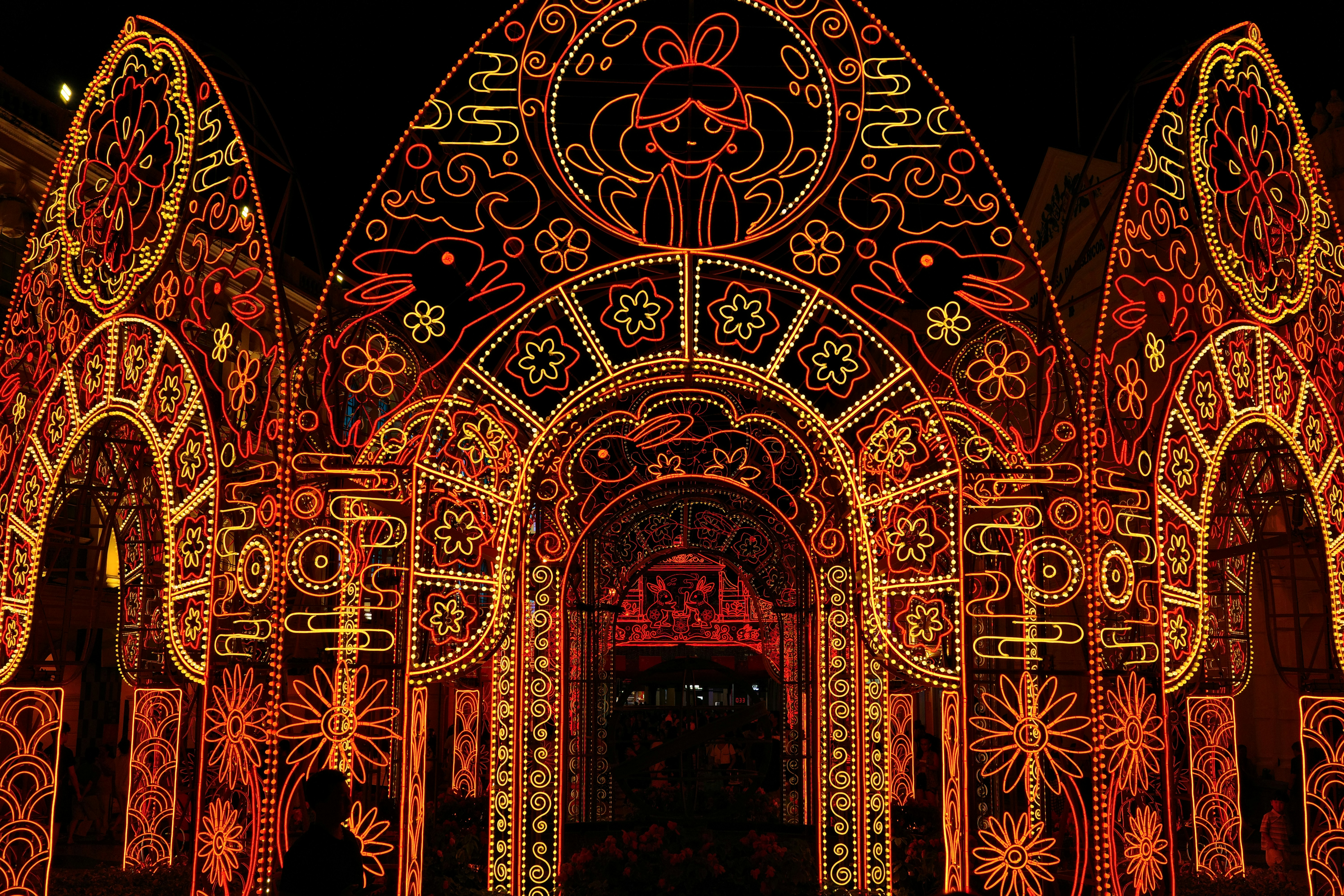 Ornate archways illuminated with intricate orange and yellow lights