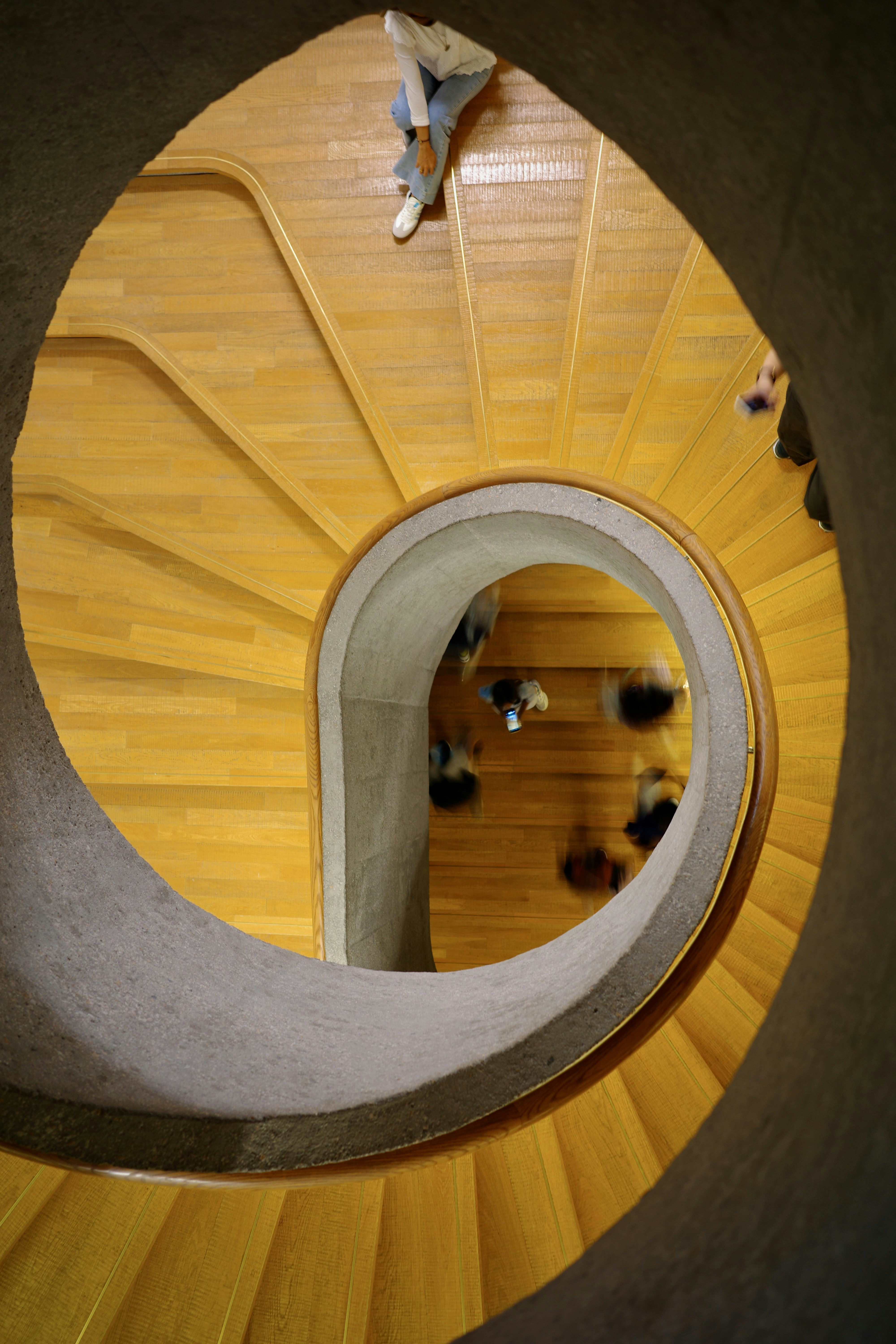 Spiral staircase with people walking down
