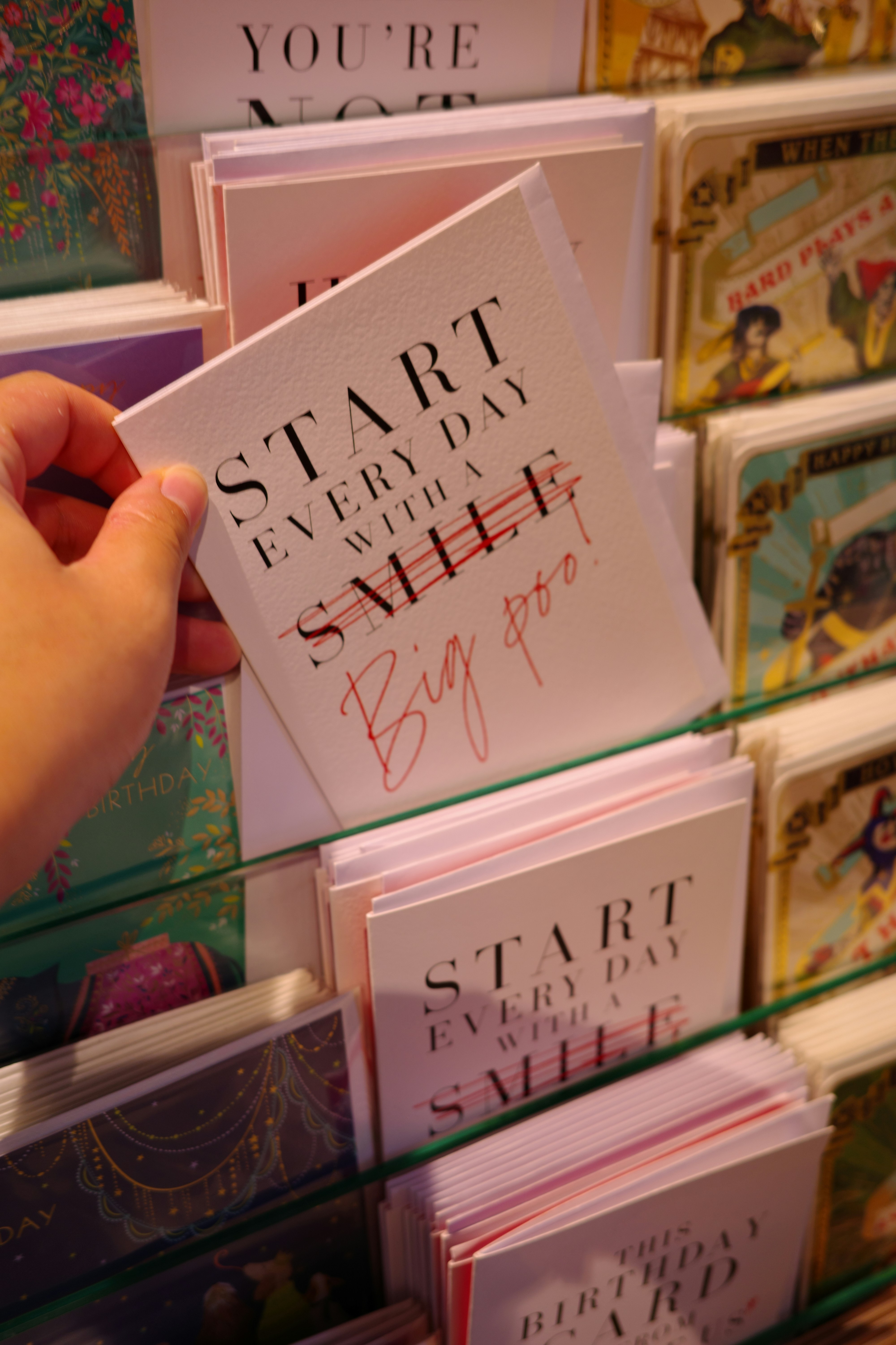 Hand holding a greeting card with text