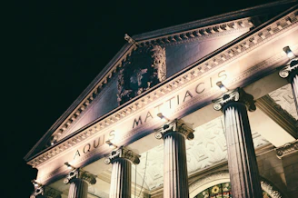 Ornate building facade with classical columns at night