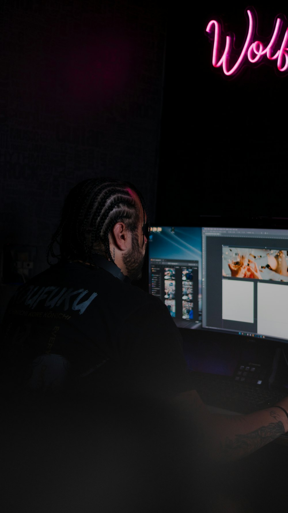 Digital artist at workstation with creative tools and multi-screen setup