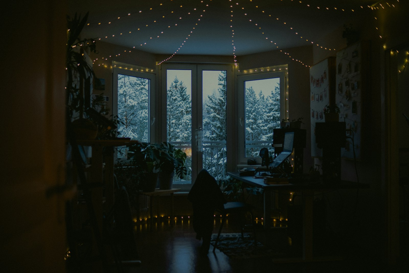 bedroom corner lit by warm fairy lights and a small lantern at night