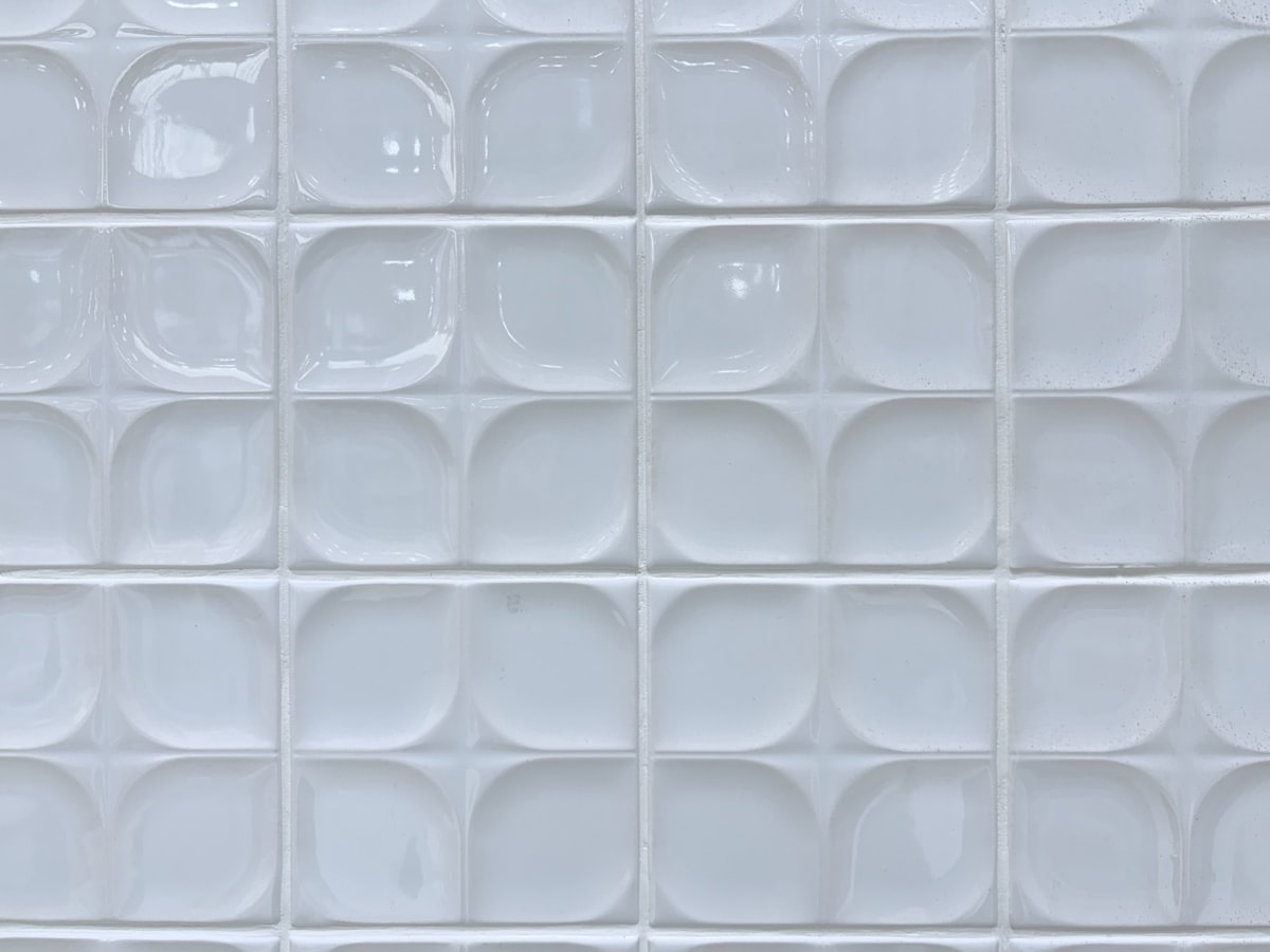Grid of textured white backsplash tiles