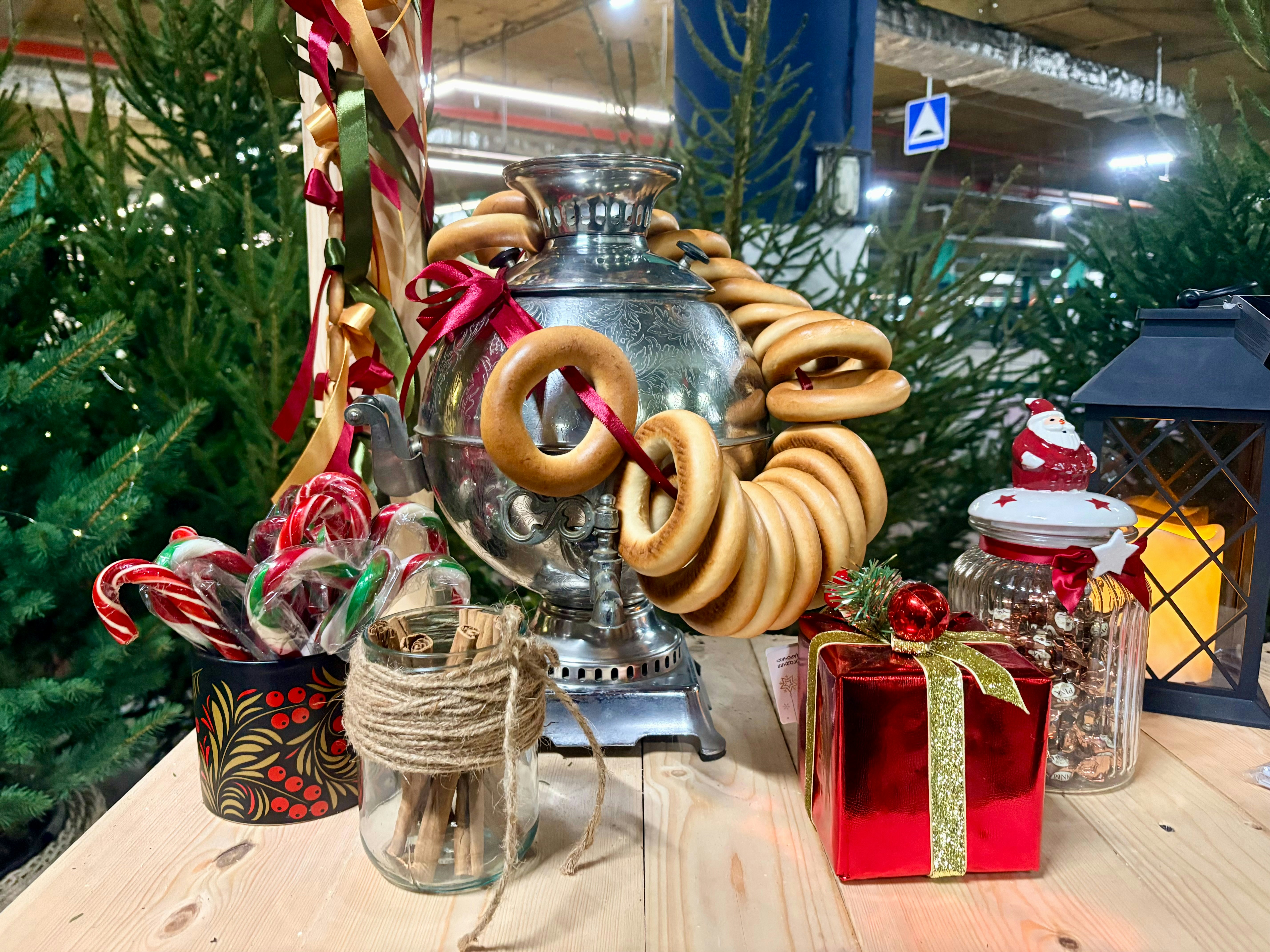 Festive display with samovar, bagels, candy canes, and gifts.