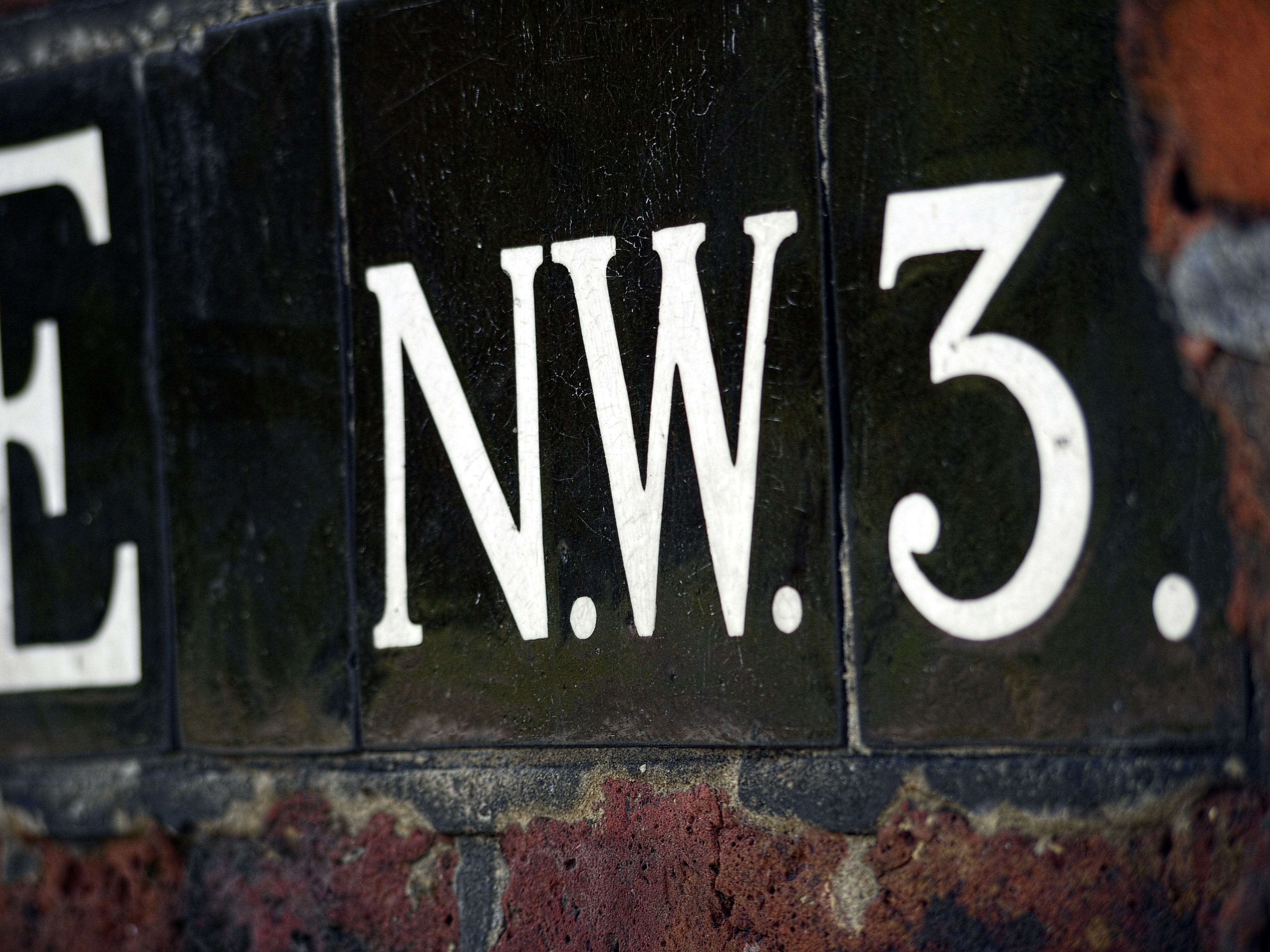 Close-up of a sign with letters nw3