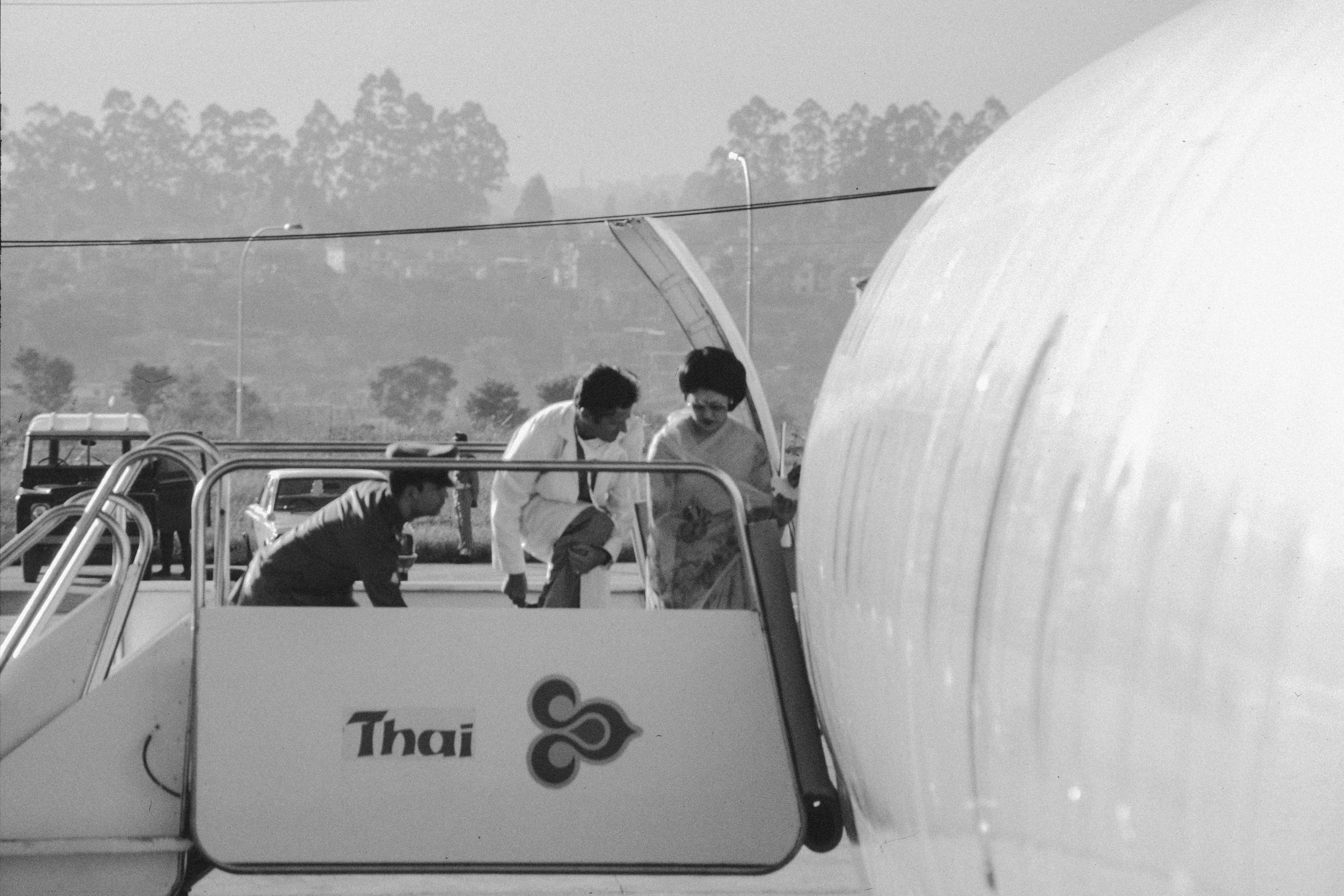 People boarding an airplane at thai airways.