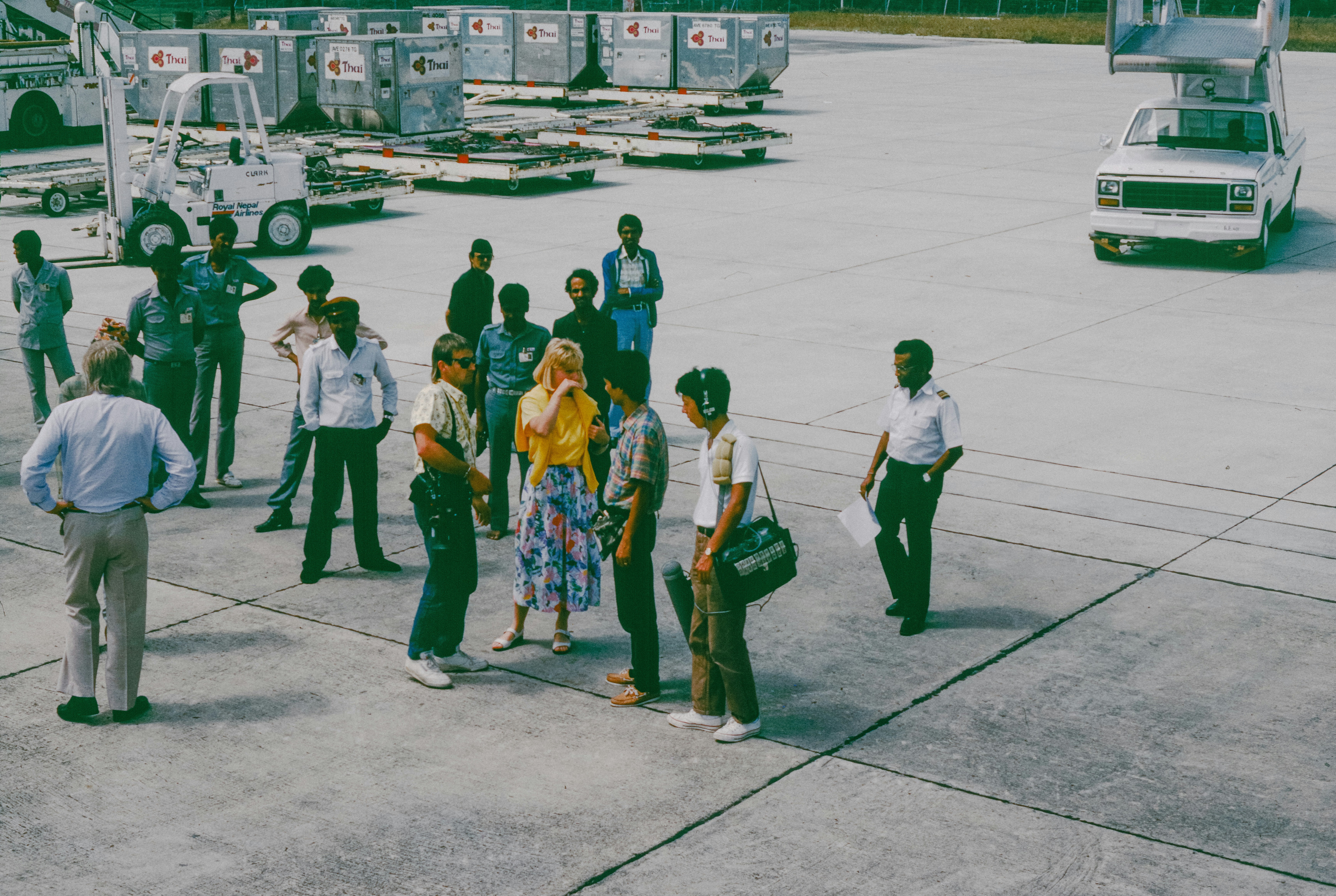 Group of people gathered on an airport tarmac